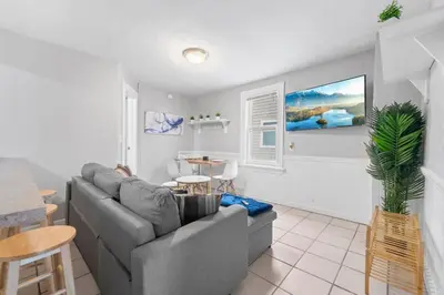 a living room with a couch and a table at Little Italy Group Stay 4 TV's Pet Friendly in Cleveland