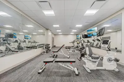 a gym with several treadmills and cardio equipment at DT Pet Friendly Parking Gym Wifi Coffee in Cleveland