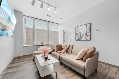 a living room with a couch and a table at DT Pet Friendly Parking Gym Wifi Coffee in Cleveland