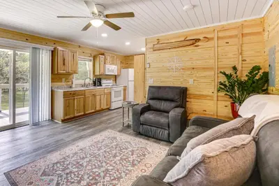 a living room with a couch and a chair at Cottage Close to Caves and Trails in Hocking Hills! in Logan