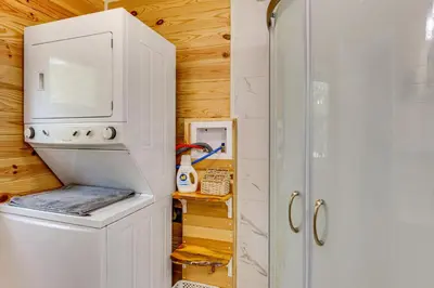 a small kitchen with a refrigerator and a washer and dryer at Cottage Close to Caves and Trails in Hocking Hills! in Logan
