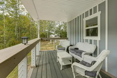 a porch with chairs and a table and a window at Cottage Close to Caves and Trails in Hocking Hills! in Logan