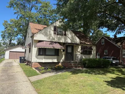 a white house with an awning on it at Westdale in Cleveland