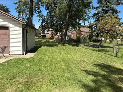 a yard with a house and a lawn with trees at Westdale in Cleveland
