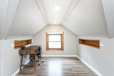 an attic office with a desk and a window at Westdale in Cleveland
