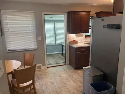 a small kitchen with a table and a refrigerator at Westdale in Cleveland
