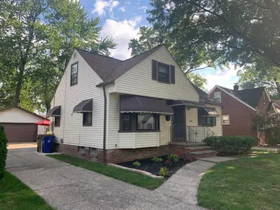 a white house with a black roof at Westdale in Cleveland