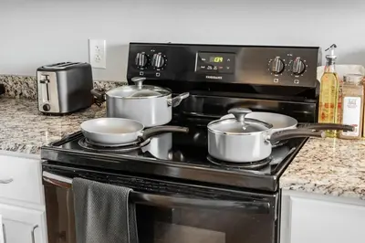 a stove with two pots on top of it at DT Fast Wifi Pet Friendly Bidet Sprayer in Cleveland