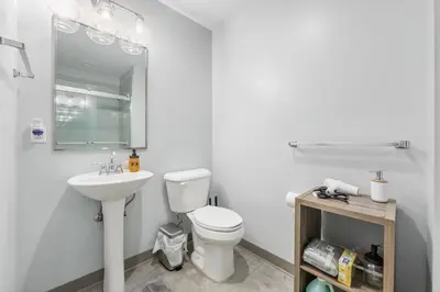 a white bathroom with a toilet and a sink at DT Gym Pet Friendly 1 Bus to Clinic or CSU in Cleveland