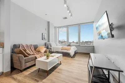 a living room with a couch and a table at DT Gym Pet Friendly 1 Bus to Clinic or CSU in Cleveland