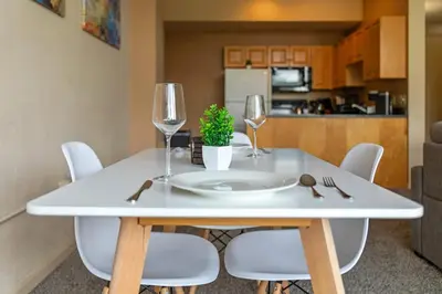 a white table with two wine glasses and a potted plant at Spacious Downtown Loft Bunkbeds 2 TVs Gym in Cleveland