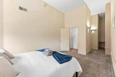 a bedroom with a large white bed in a room at Spacious Downtown Loft Bunkbeds 2 TVs Gym in Cleveland