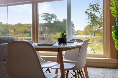 a dining room table with wine glasses and chairs at Spacious Downtown Loft Bunkbeds 2 TVs Gym in Cleveland