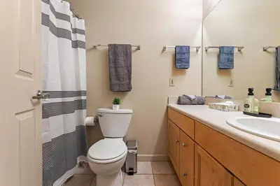 a bathroom with a toilet and a sink at Spacious Downtown Loft Bunkbeds 2 TVs Gym in Cleveland