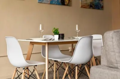 a dining room table with white chairs and a table and a couch at Spacious Downtown Loft Bunkbeds 2 TVs Gym in Cleveland