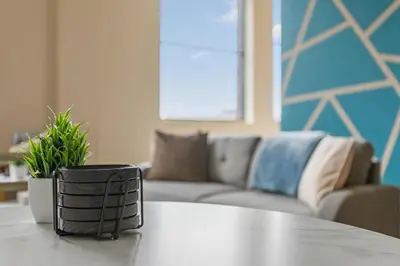 a table in a living room with a couch at Downtown Gym Sauna Parking Pet Friendly in Cleveland