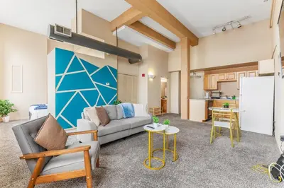a living room with a couch and a table at Downtown Gym Sauna Parking Pet Friendly in Cleveland