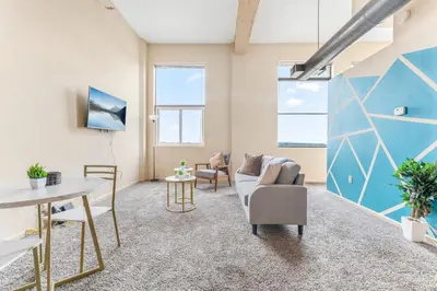 a living room with a couch and a table at Downtown Gym Sauna Parking Pet Friendly in Cleveland
