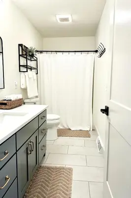 a bathroom with a toilet and a shower curtain at Country Comfort with Pool Family & Groups in Dundee