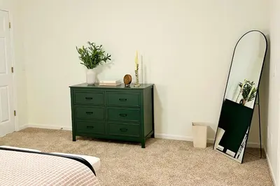 a bedroom with a green dresser and a mirror at Country Comfort with Pool Family & Groups in Dundee