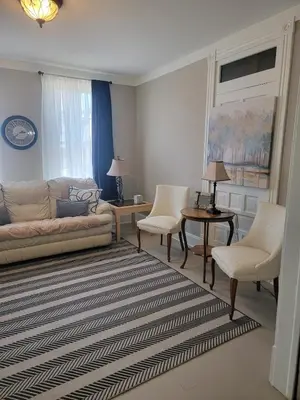 a living room with a couch and two chairs at 1895 meets 2025 Townhouse in Hamilton