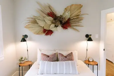 a bedroom with a bed with a flower on the wall at 