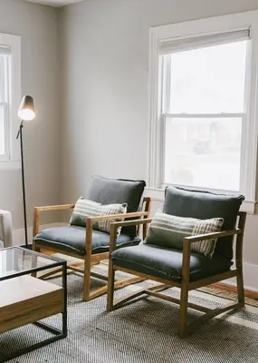 a living room with two chairs and a coffee table at 