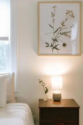 a bedroom with a bed and a table with a lamp at 