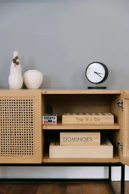 a book shelf with a clock and books at 