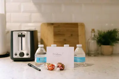 a table with bottles of water and two tomatoes at 