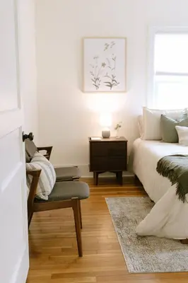 a bedroom with a bed and a chair and a table at 