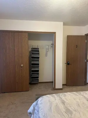 a bedroom with a bed and a closet and a door at quiet and comfortable in Cleveland