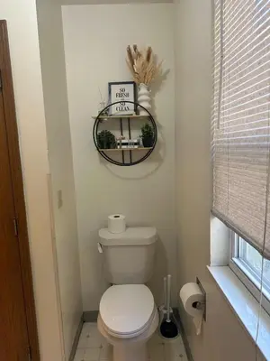 a bathroom with a toilet and a sign on the wall at quiet and comfortable in Cleveland