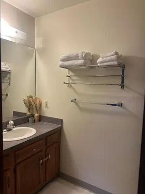 a bathroom with a sink and a mirror and towels at quiet and comfortable in Cleveland