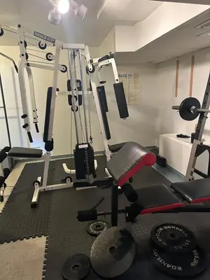 a gym with several treadmills and weights at quiet and comfortable in Cleveland