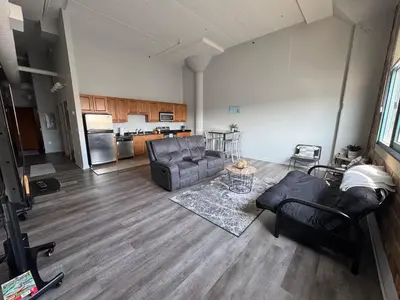 a living room with two couches and a kitchen at Spacious Condo Minutes to Cedar Point in Sandusky
