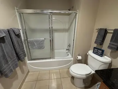 a bathroom with a shower and a toilet and a sink at Spacious Condo Minutes to Cedar Point in Sandusky