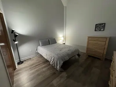 a bedroom with a bed and a dresser at Spacious Condo Minutes to Cedar Point in Sandusky
