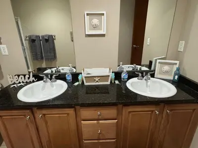 a bathroom with two sinks and a large mirror at Spacious Condo Minutes to Cedar Point in Sandusky