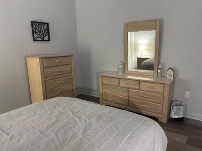 a bedroom with a bed and a dresser and a mirror at Spacious Condo Minutes to Cedar Point in Sandusky
