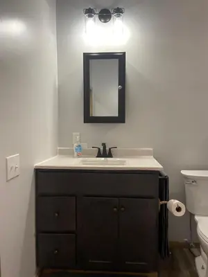 a bathroom with a sink and a mirror at Hillside Haven in Warsaw