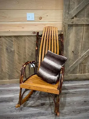 a wooden rocking chair with a pillow on it at Hillside Haven in Warsaw