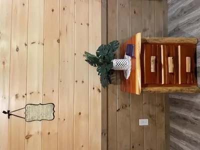 a wooden cabinet on a wooden wall with a plant at Hillside Haven in Warsaw