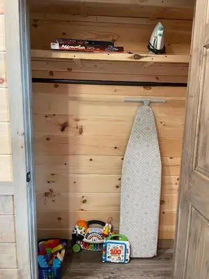 a childs closet with a wooden wall with toys at Hillside Haven in Warsaw