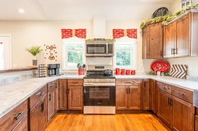 a kitchen with wooden cabinets and stainless steel appliances at White Fern