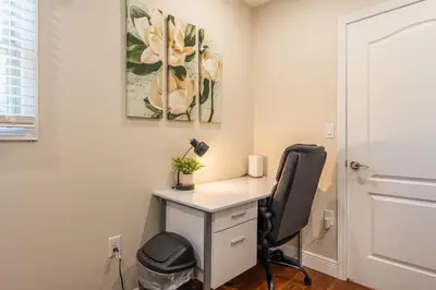 a home office with a desk and a chair at White Fern