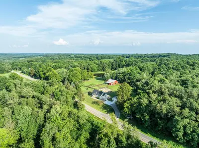 an aerial view of a house in the middle of a forest at White Fern