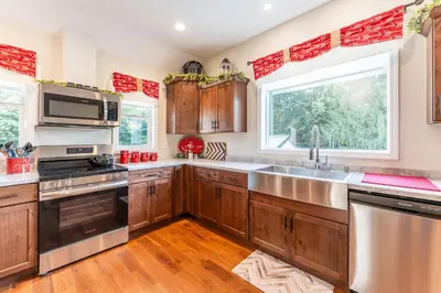 a kitchen with wooden cabinets and a large sink at White Fern