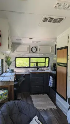 a kitchen in an rv with a sink and a counter at Whispering Pines Retreat (RV) in Glenmont