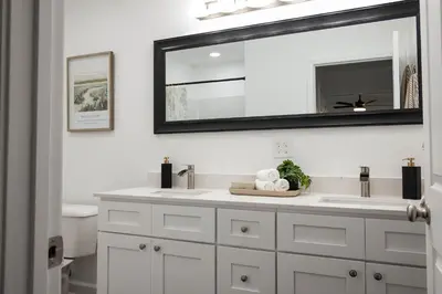 a bathroom with a sink and a mirror at Creek View Cottage